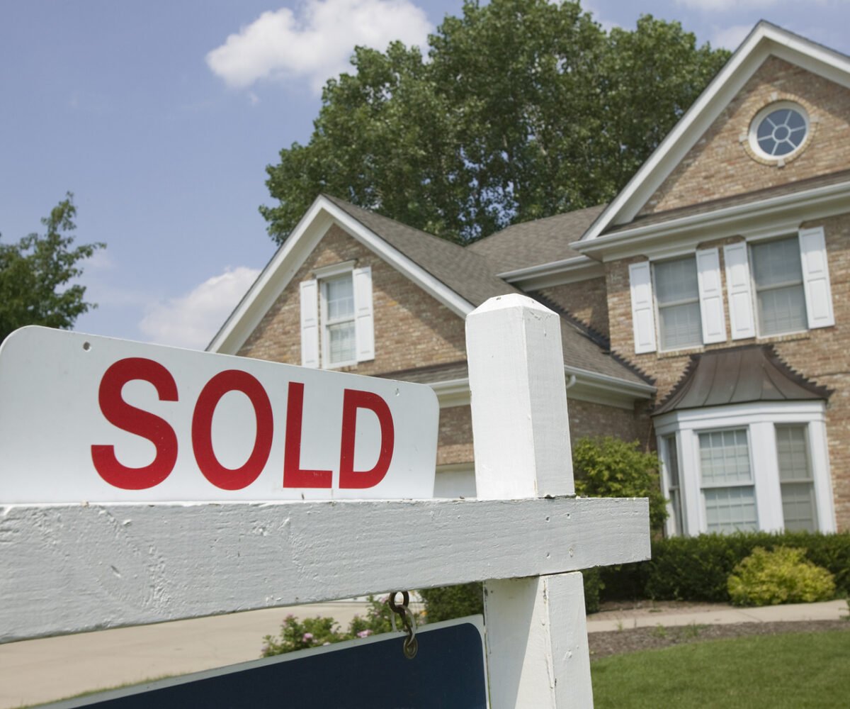 A sold sign in front of a house.