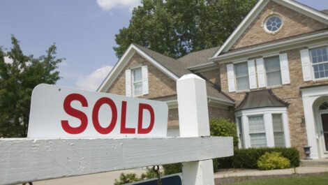 A sold sign in front of a house.