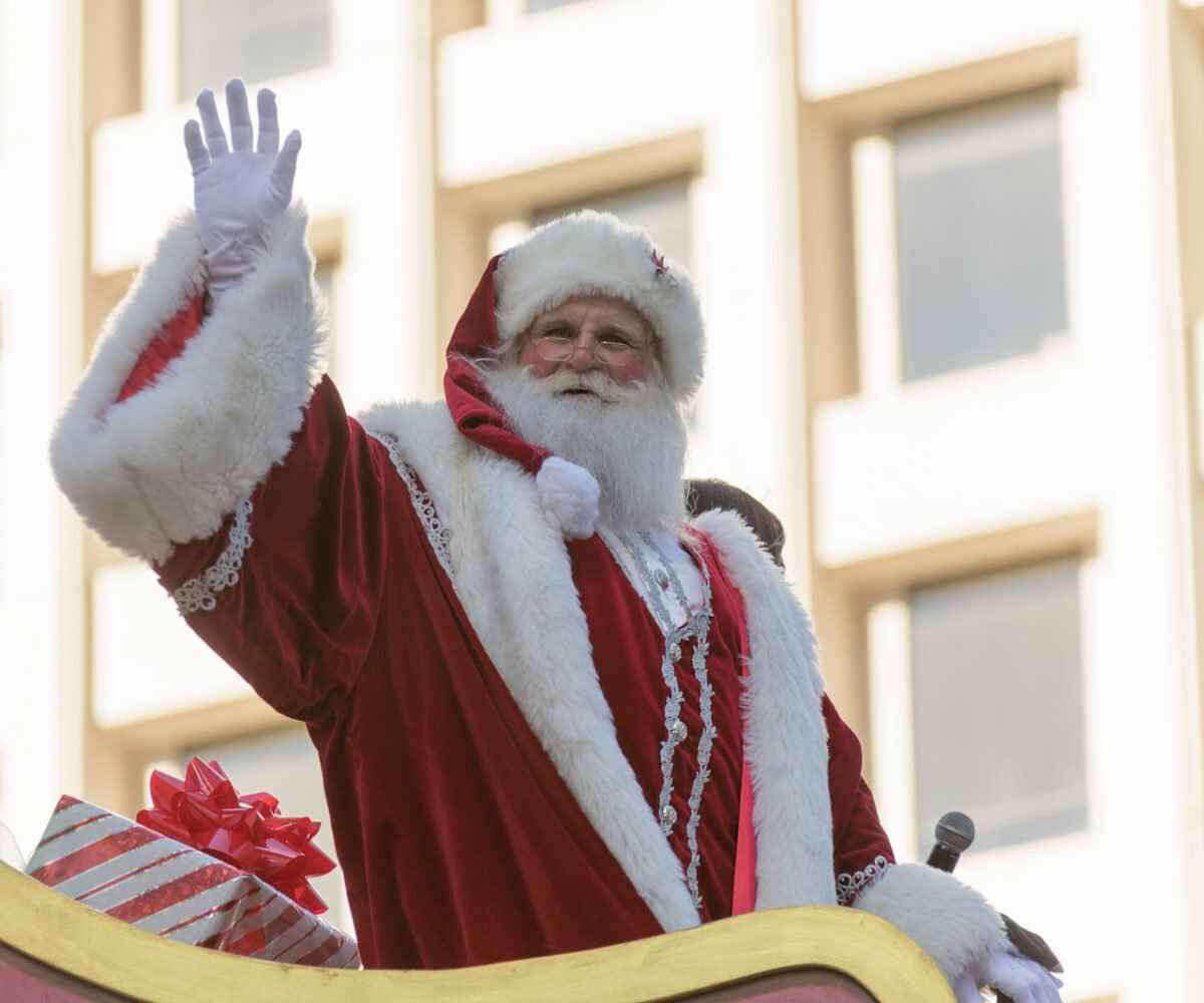 Santa waving at a Thanksgiving parade.