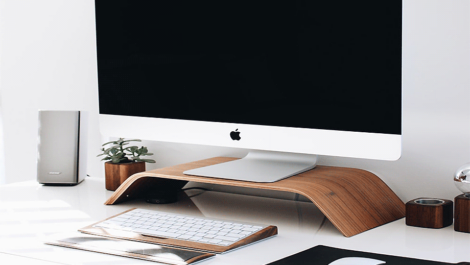 Apple desktop computer on a home office desk.