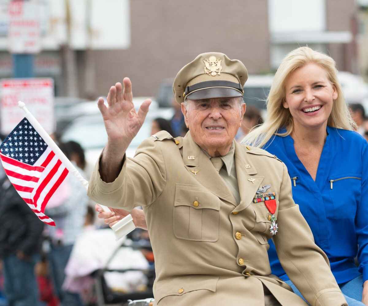 A US Veteran smiles and waves at a Memorial Day event in Michigan.