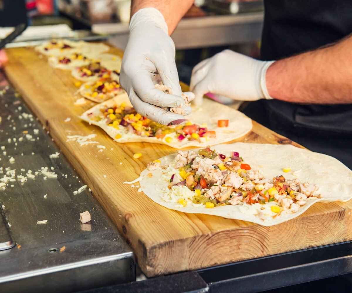 A chef making tacos in a food truck.