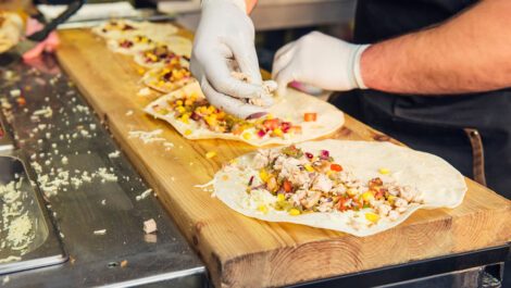 A chef making tacos in a food truck.