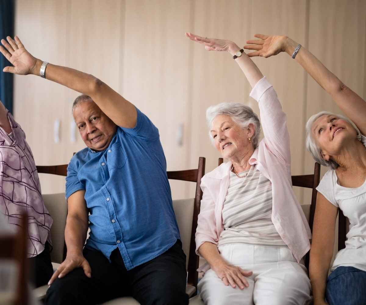 Four seniors stretching in a class.