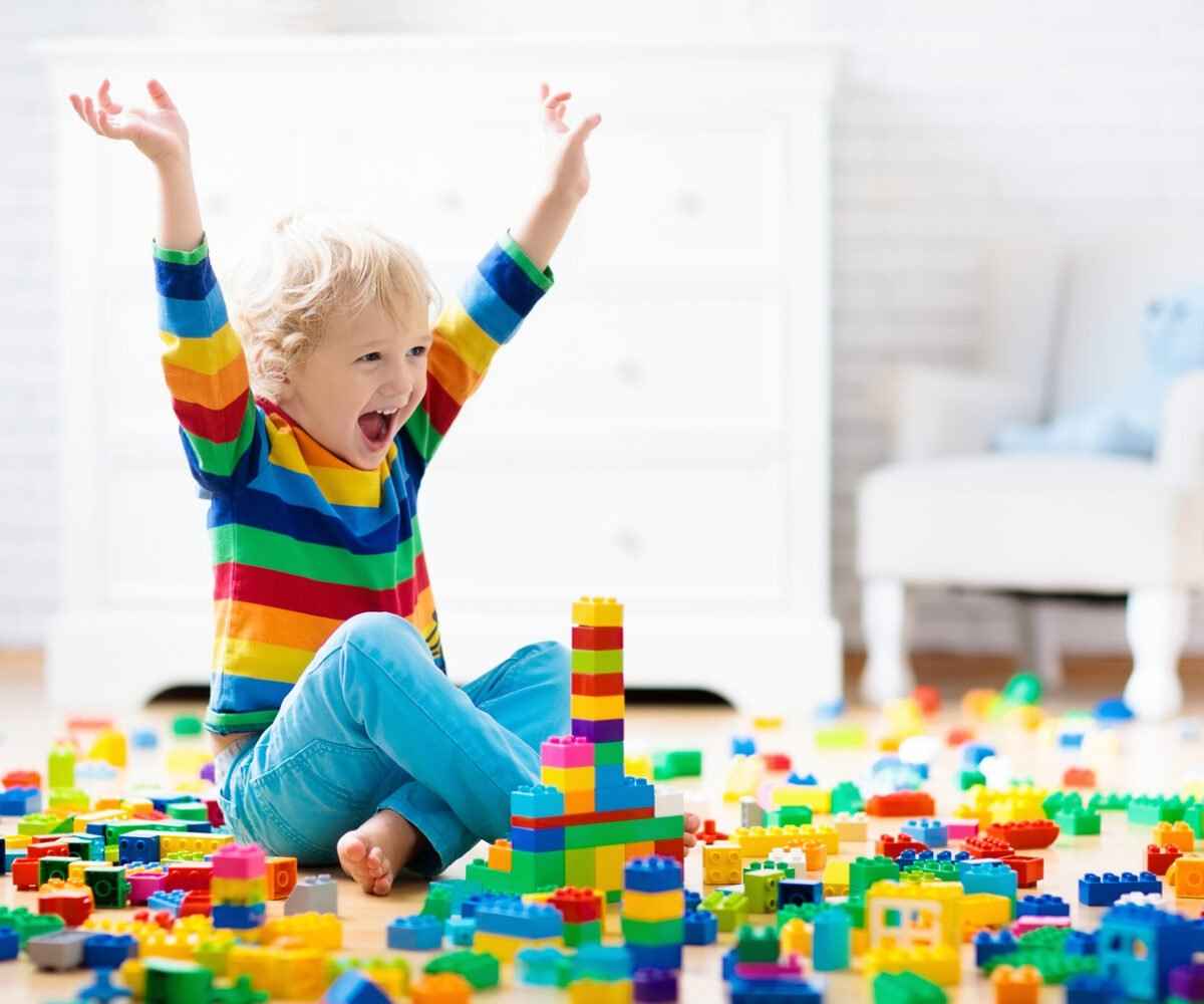 A young child playing with legos in a playroom.