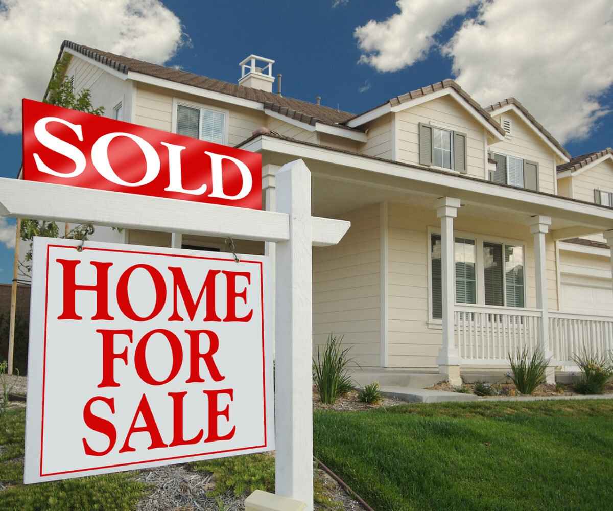 Home with a sold sign in front yard.