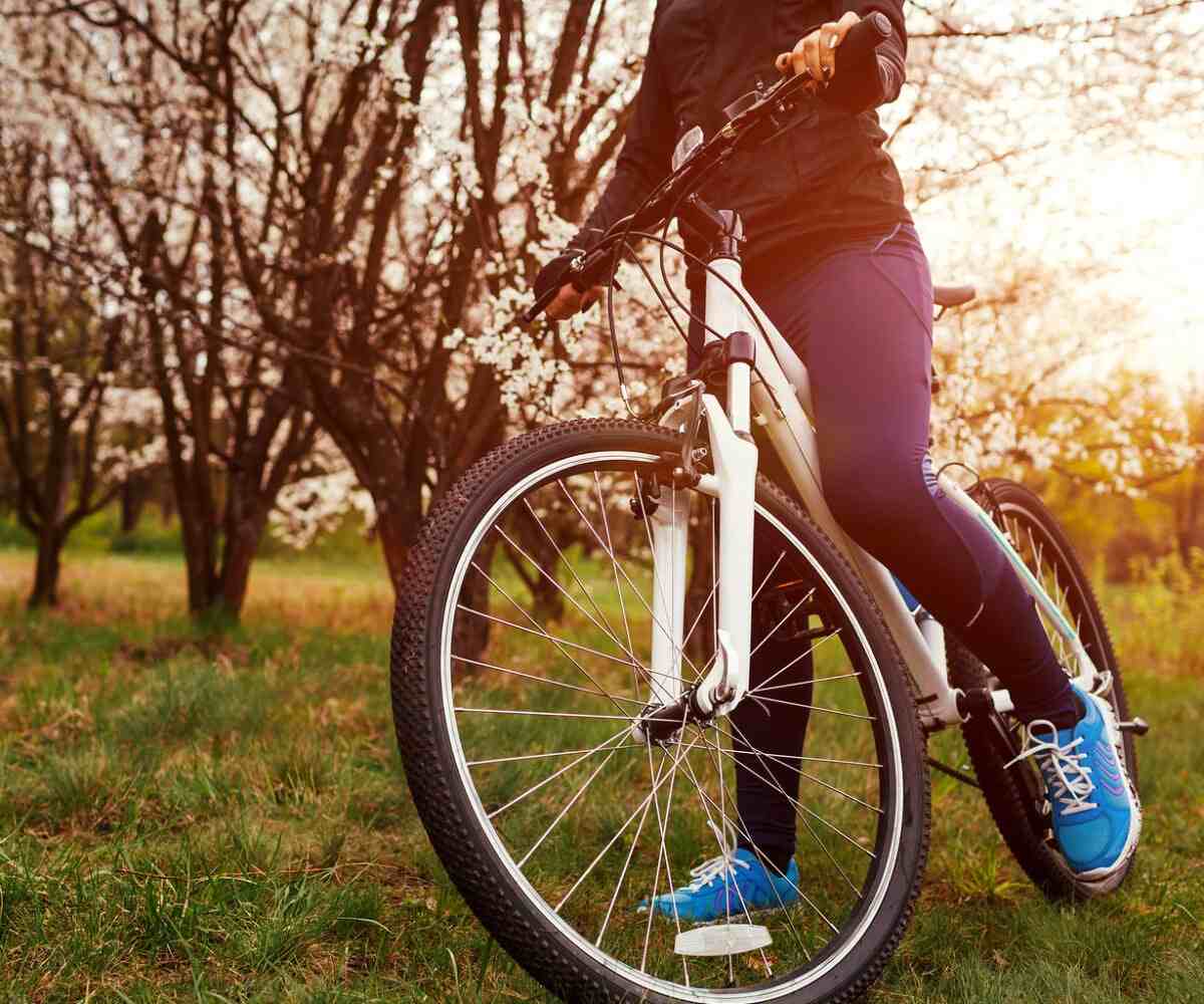 A person riding a bike in a grass field.