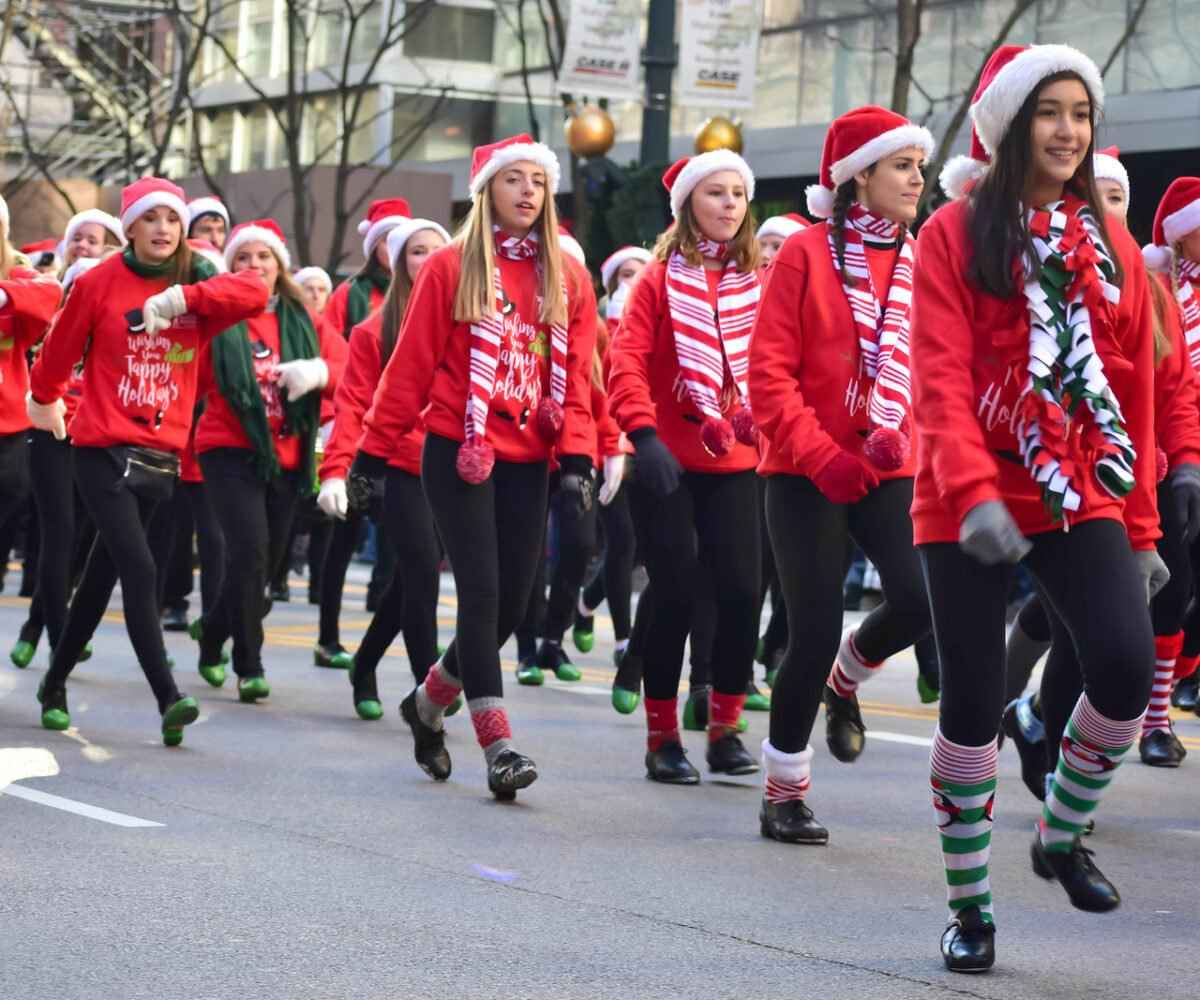 Group of young females walking in a parade.