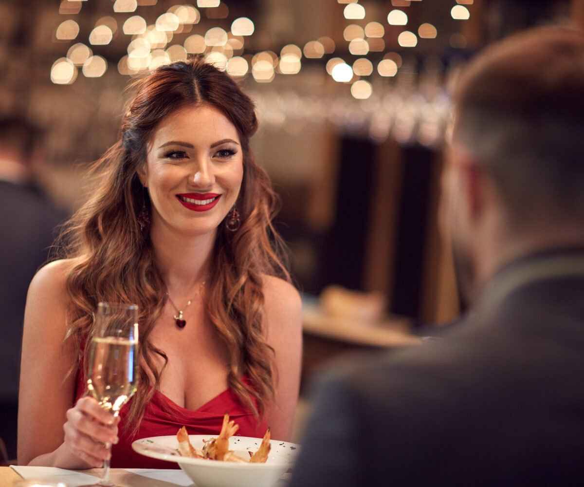 Young couple eating dinner at a fancy restaurant.