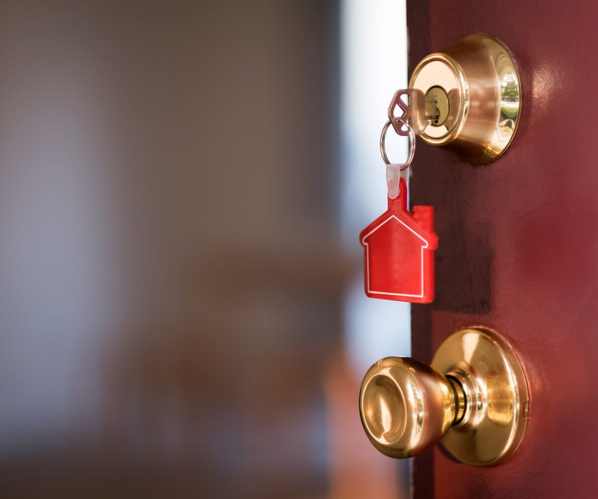 A door with a house key in it.