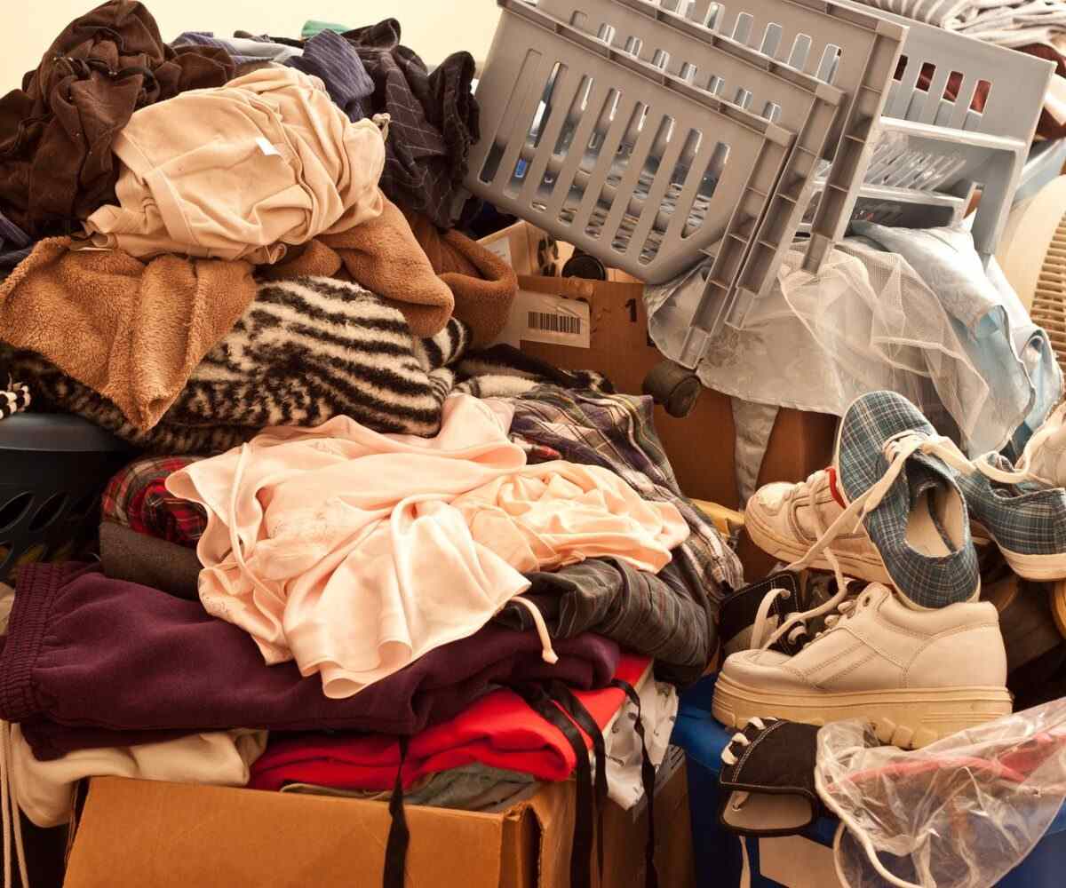 A large pile full of clothes and shoes.