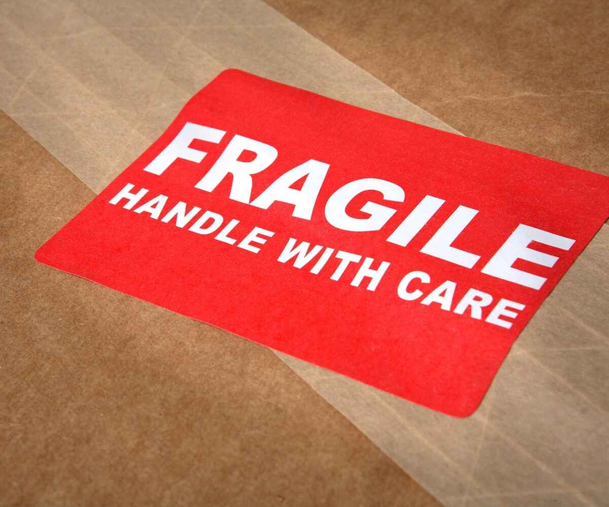 Fragile Handle With Care sticker on a box.