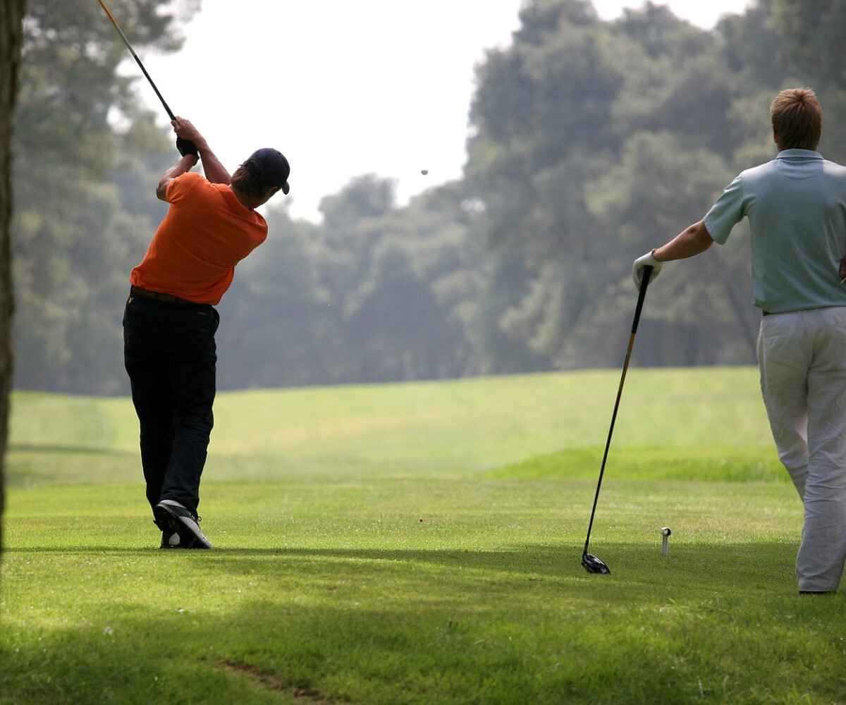Two men golfing.