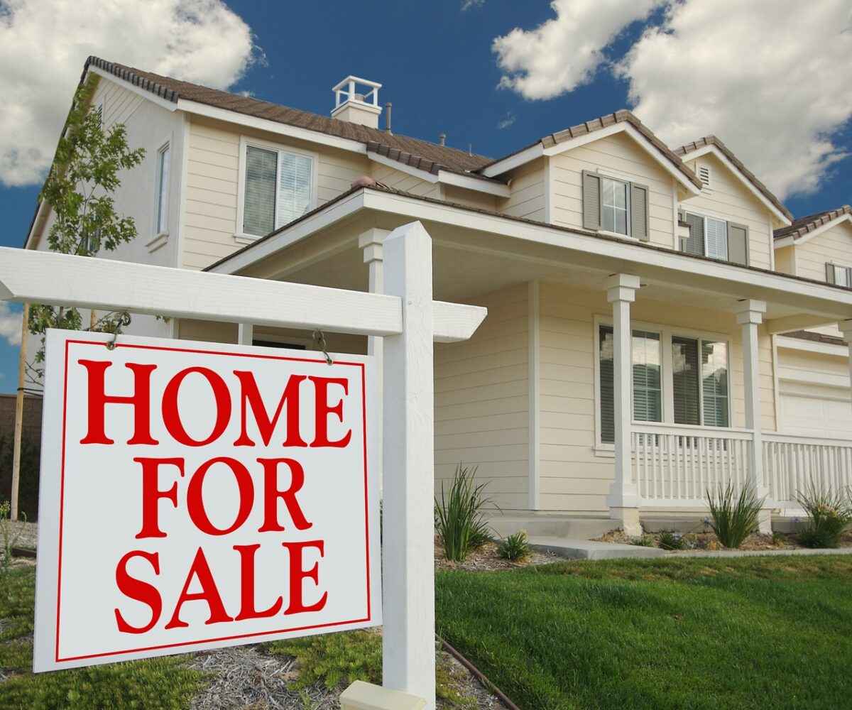 Home For Sale sign in front of a house.