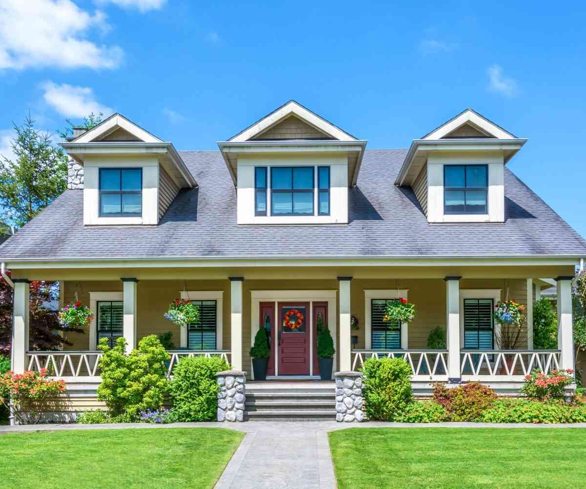 Front of a luxury home on a sunny day.