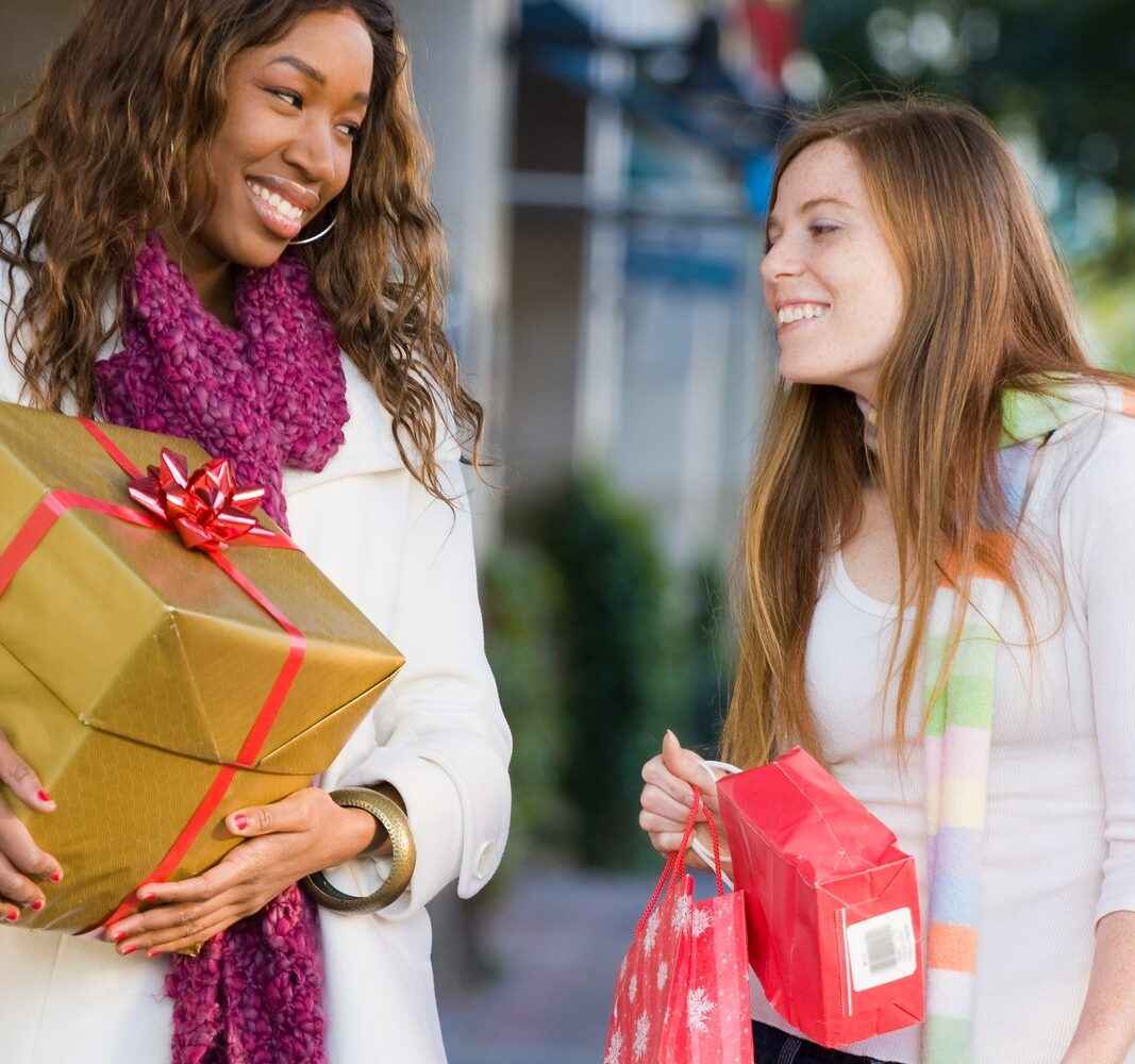 Two young women holiday shopping together.