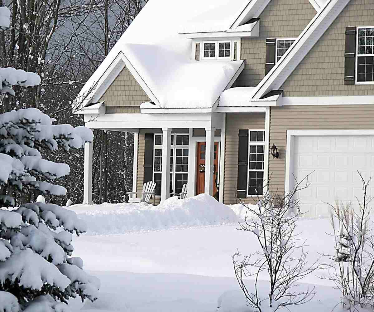 A house covered in a blanket of snow.