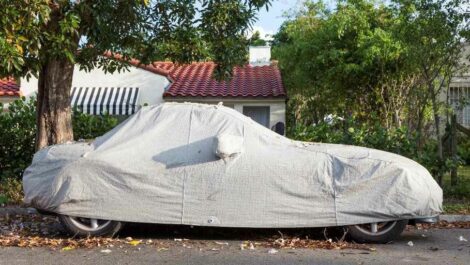 A car being stored in a car cover.