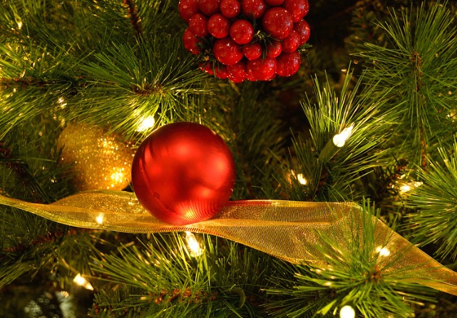 A decorative Christmas tree with a red ornament and white lights